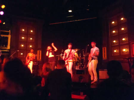 SAN FRANCISCO - OCTOBER 24: Singer lifts hand in air as 80's Cover band Strong Like Bull plays music on stage taken October 24, 2010 at the Broadway Studios San Francisco.のeditorial素材