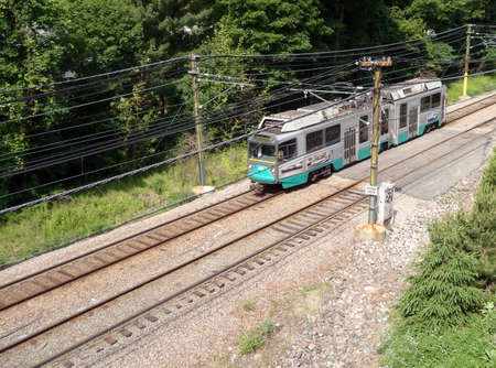 BOSTON, MA - MAY 30: Boston T Green line train races down track an a section of track surrounded by trees.  May 30, 2010 Boston. のeditorial素材