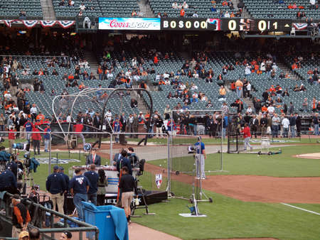 SAN FRANCISCO, CA - OCTOBER 28: MLB Network crew prepares for broadcast as players take batting practice in background with coach Ron Washington throwing game 2 of the 2010 World Series game between Giants and Rangers Oct. 28, 2010 AT&T Park San Franciscoのeditorial素材