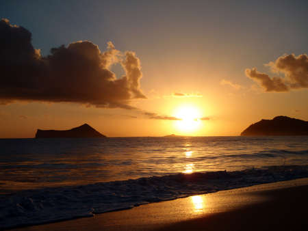 Sunrises over Kaohikaipu (Black/Turtle) Islands with the Maka'Pua lighthouse, Rabbit and Molokai Island visible in the distance.の写真素材