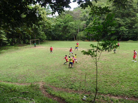 PUNTA BANCO, COSTA RICA - JULY 19: Native Costa Ricans Play Soccer on a field in the Woods fighting for control of the ball.  Punta Banco woods, Costa Rica July 19, 2009.のeditorial素材