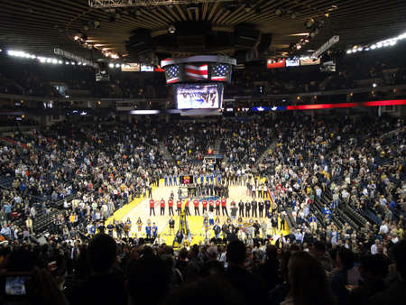 OAKLAND, CA - JANUARY 17: Nets vs. Warriors: Basketball Players and Oakland fans stand with hats...