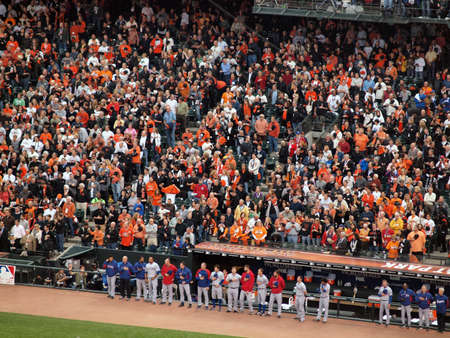 SAN FRANCISCO, CA - OCTOBER 28: Ranger Players stand with hats removed in front of the dugout during national anthem as do fans in the stands game 2 of the 2010 World Series game between Giants and Rangers Oct. 28, 2010 AT&T Park San Francisco, CA. のeditorial素材