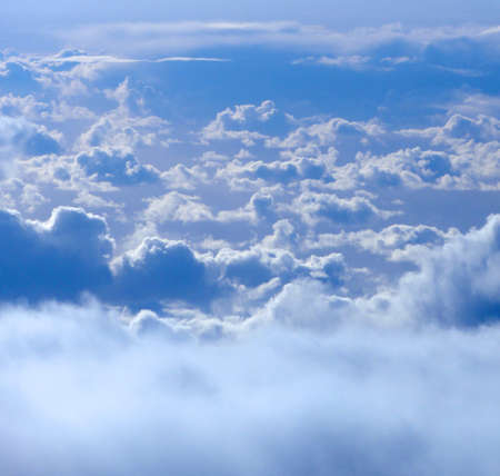 floating above and on top of fluffy curvy clouds as far as the eye can seeの写真素材