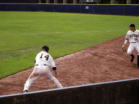 BERKELEY, CA - FEBRUARY 20: Utah vs. California - Cal player Tony Renda dig ball out of dirt and sets to throw into the infield as another player backs him up at Evans Diamond taken February 20, 2011 Berkeley California. のeditorial素材