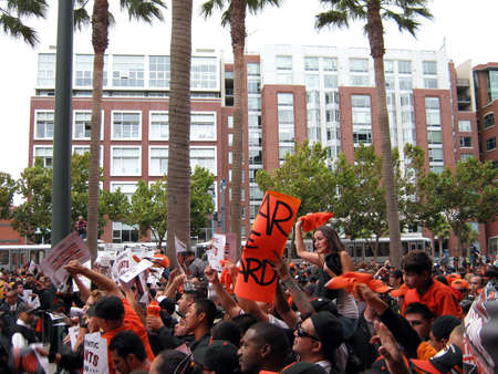 SAN FRANCISCO - OCTOBER 2: Padres vs. Giants: Giants Fans go crazy cameras during for live broadcast of Comcast Sports show outside after winning the NL West Division. taken on October 3 2010 at Att Park in San Francisco California. のeditorial素材