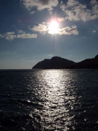 Sunrises over Maka'pua Point and reflects over the bay on Oahu, Hawaiiの写真素材