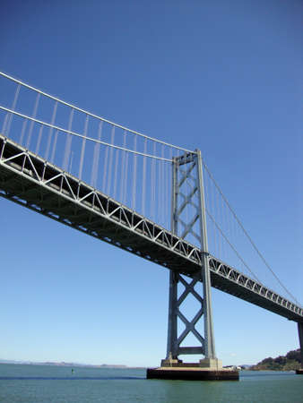 Bay Bridge spanning San Francisco Bay viewed from the water.の写真素材