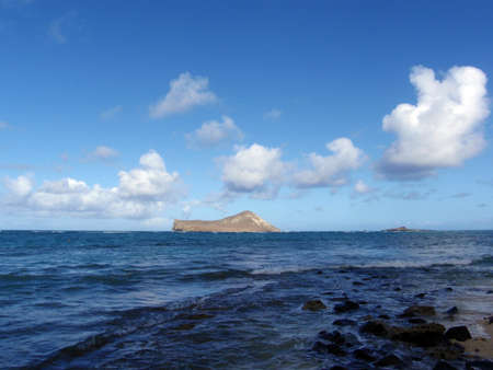 Rocky Waimanalo Beach on Oahu, Hawaii. With  rabbit and rock island seen in the distanceの写真素材