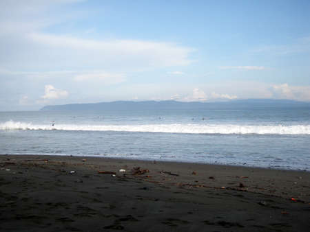 People wait for waves in the surf in Pavones, Costa Rica.の写真素材
