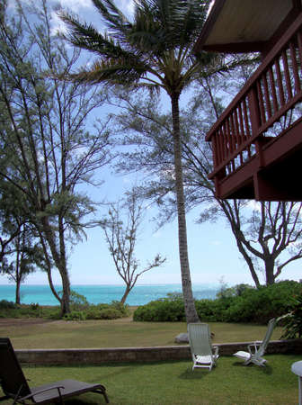 Path to the beach from home with lawn chairs and grass area の写真素材