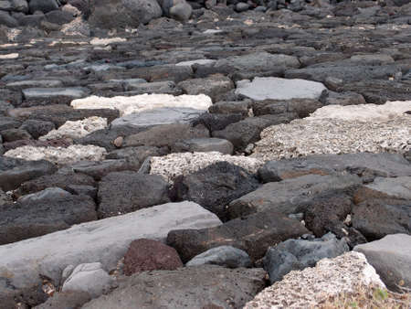 Lava Rock Wall Pattern featuring a variety of colors of rocks の写真素材