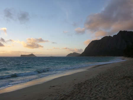 Waimanalo Beach at dawn on Oahu, Hawaii with Rabbit and Rock island seen in the distance as well as Makapuu point の写真素材