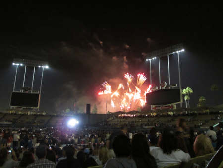 LA, CA - JULY 13: Fireworks explore above Dodger Stadium as crowd watches after a baseball game on July 13, 2012 Dodger Stadium LA.のeditorial素材