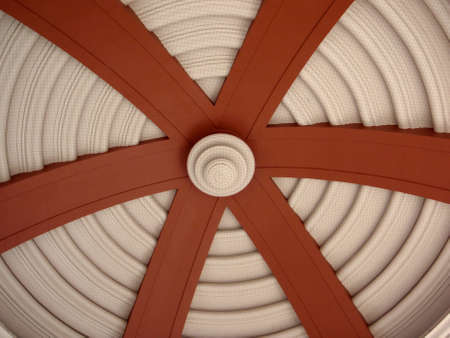 Underside of Dome with circle pattern and large red arches leading towards center with netting to protect from birds   In San Jose, Costa Rica の写真素材