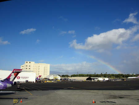 HONOLULU, HI - FEBUARY 18: Rainbow over Hawaiian Airlines section of the Honolulu International Airport with plane tails visble.  Taken Febuary 18, 2013 on Oahu, Hawaii.のeditorial素材