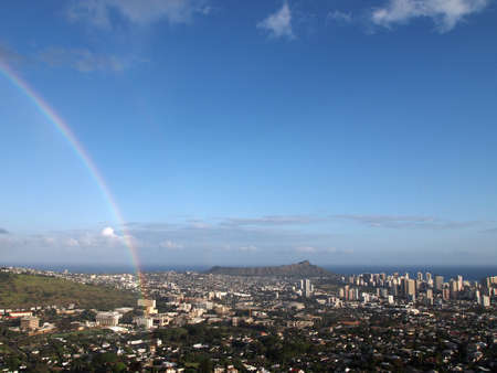 Rainbow over Manoa, the city of Honolulu, and Diamond Head on the island of Oahu in the state of Hawaii on a beautiful day.の写真素材