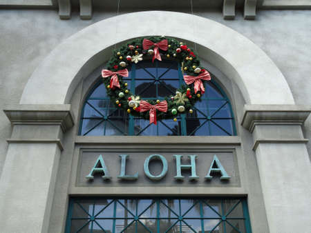 The Word Aloha and Christmas Wreath on side of Aloha Tower building. Aloha Tower is a lighthouse that is considered one of the landmarks of the state of Hawaii in the United States. Opened on September 11, 1926.のeditorial素材