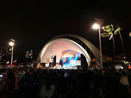 HONOLULU, HI - JULY 30: crowd of People and band on stage at the FM 100 Birthday Bash at Waikiki Shell, Honolulu, Hawaii March 23, 2013.のeditorial素材
