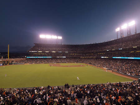 SAN FRANCISCO CA - JUNE 7: Outfielders run for ball with whole ballpark in view on June 7 2011 in San Francisco.のeditorial素材