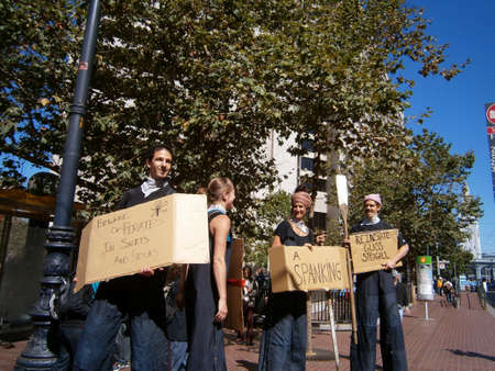 SAN FRANCISCO, CA - OCTOBER 7: Protesters in outfits hold Signs saying things the corruption on Wall Street and big business in America on Market Street in the downtown area on October 7, 2011 in San Francisco.のeditorial素材