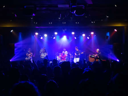 HONOLULU - DECEMBER 14, 2013: Reggae band Groundation jams on stage with lead singer singing into lower mic and other members of band play music at concert at the Republik.のeditorial素材
