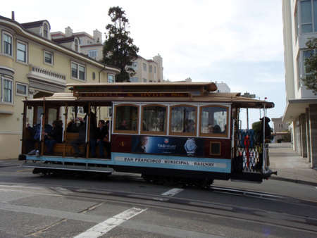 SAN FRANCISCO - FEBRUARY 6: Historic Powell & Hyde Sts. Muni Trolley Car crosses street as Passengers enjoy a ride in the cable car on February 6, 2008 in San Francisco. It is the oldest mechanical public transport in San Francisco which is in service sinのeditorial素材