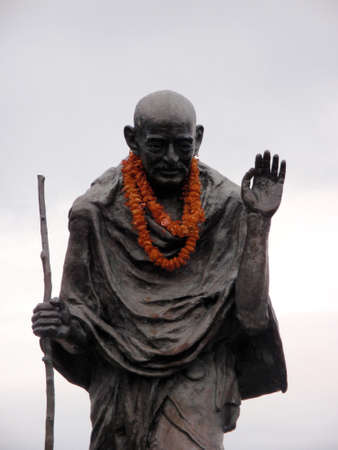 Statue of Ghandi wearing an orange lei in the Embarcadero center, San Francisco, Californiaのeditorial素材
