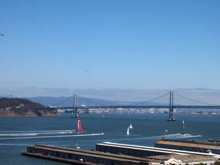 SAN FRANCISCO-SEPT 14:  Oracle Team USA and New Zealand Team race toward the Bay Bridge during the race of America's Cup with boats and helicopters following on Sept. 14, 2013 in San Francisco. USA won the race in a historic comeback.のeditorial素材
