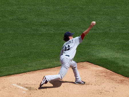 Red Sox vs. Athletics: Red Sox starting pitcher Clay Buchholz throws ball in bullpen before start of game. Ball can be seen leaving hand.  Taken on July 21, 2010 at the Coliseum in Oakland California.のeditorial素材