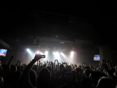 HONOLULU, HI - MARCH 30: Jurassic 5 raps on stage as Crowd hold hands and cellphone in air as lights overwhelm stage. Taken March 30, 2014 at Republik, Honolulu, Hawaii.のeditorial素材