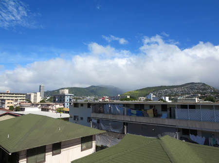 Apartments and homes in area looking towards mountain range on Oahu, Hawaii.の写真素材