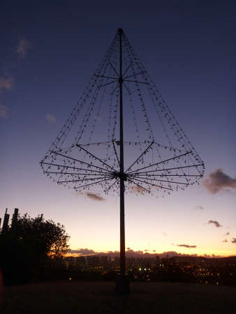  the Kaimuki Christmas tree (Metal Light Tree) on top Pu'u O Kaimuki (also known as Menehune Hill) at dusk on with cityscape of Oahu, Hawaii.の写真素材