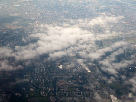 Clouds hover over Washington DC area aerial cityscape.                               の写真素材
