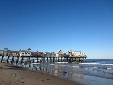 PORTLAND, MAINE - JUNE 3:Waves lap Historic under Historic Old Orchard Beach Pier, which since 1898...