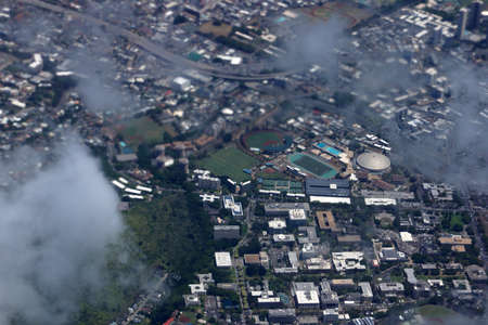 Aerial view of Landmark University of Hawaii Baseball Les Murakami Stadium, Stan Sheriff Center, and college campus in Manoa with H-1 Highway and Surrounding town community Honolulu, Hawaii June 13, 2014.のeditorial素材