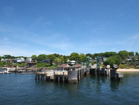 PORTLAND, MAINE - JUNE 2: Peaks Island Pier and surrounding town which has daily ferry service by Casco Bay Ferries in Portland, Maine seen from the water, June 2, 2014.のeditorial素材