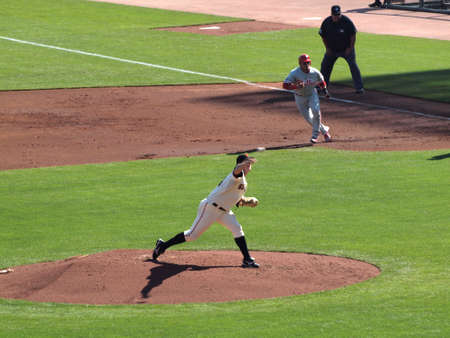 SAN FRANCISCO, CA - OCTOBER 19: San Francisco Giants vs. Philadelphia Phillies: Giants Matt Cain throws pitch, which can be seen leaving his hand as runner takes lead from 1st base during game three of the NLCS 2010 taken October 19, 2010 AT&T Park San Frのeditorial素材