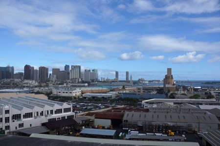 Aerial view of the Honolulu Port and downtown skyline with landmarks Aloha Tower, Nimitz Highway, and modern skyscrapers on Oahu, Hawaii.の写真素材
