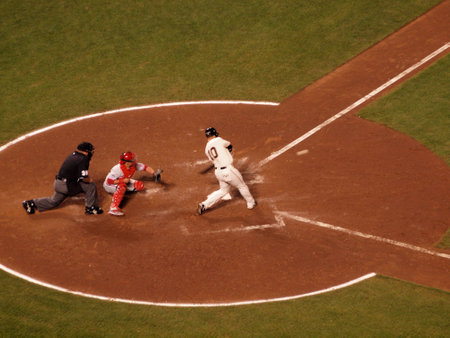 SAN FRANCISCO, CA - OCTOBER 20: Giants Travis Ishikawa Swings hard at incoming pitch with phillies catcher Carlos ruiz catching game 4 of the 2010 NLCS game between Giants and Phillies Oct. 20, 2010 AT&T Park San Francisco, CA.のeditorial素材