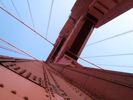 Upward perspective of Art Deco Tower and supporting cables on the Golden Gate Bridge.の写真素材