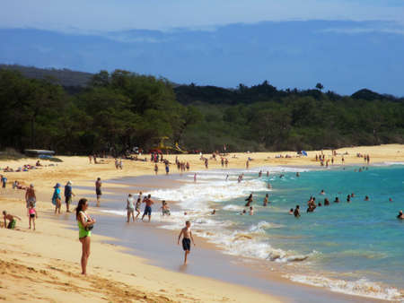 MAUI, HAWAII, USA - FEBRUARY 18, 2013: People play in the waves and shore at Big Beach on the sunny south coast of Maui, Hawaii.のeditorial素材