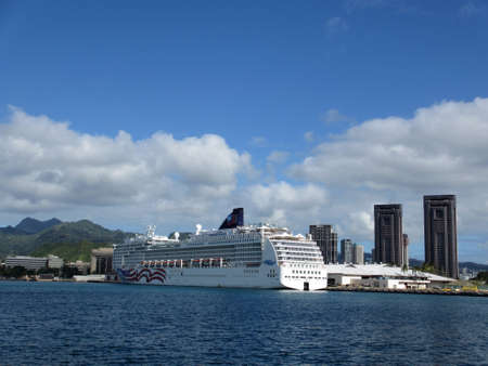 HONOLULU, HI - JANUARY 7: NCL Cruiseship, Pride of America,  docked in Honolulu Harbor with city and mountains in the distance.  taken May 19, 2012 Honolulu, Hawaii.のeditorial素材