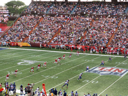 HONOLULU - JANUARY 29: AFC Placekicker Sebastian Janikowski of the Oakland Raiders team kicks off ball to NFC football team, the All-star Players are in motion during play with crowd and sideline in view during ProBowl Game taken January 29, 2012 in Honolのeditorial素材