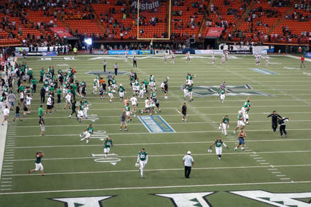 HONOLULU, HI - NOVEMBER 22: UNLV vs. UH: University of Hawaii players and fans rush on the field to celebrate win before game is official over at night (fans and players were forced to return to off the field so game could be complete). taken on November のeditorial素材