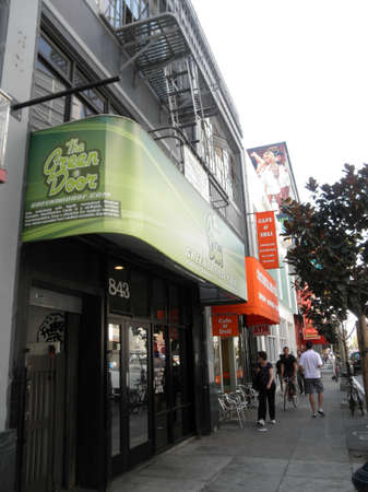 SAN FRANCISCO - SEPTEMBER 28:  People move along the sidewalk in front fo the Green Door, medical marijuana pot shop store in SOMA taken on September 28, 2011 in San Francisco.のeditorial素材