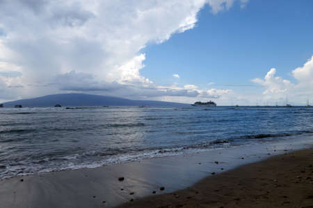 LAHAINA, HI - SEPTEMBER 30: Beach with Princess Cruise Ship docked along with other boats off coast of Maui with Lanai in the distance a passengers take small boat to shore on September 30, 2014.のeditorial素材