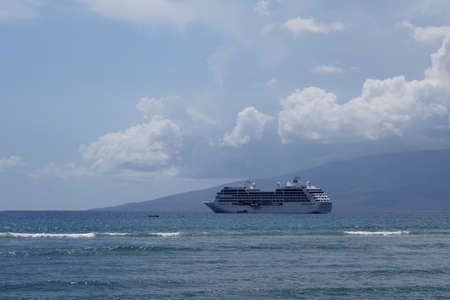 LAHAINA, HI - SEPTEMBER 30: Princess Cruise Ship docked offf coast of Maui with Lanai in the distance a passengers take small boat to shore on September 30, 2014. The Princess brand is owned by Carnival Corporationのeditorial素材