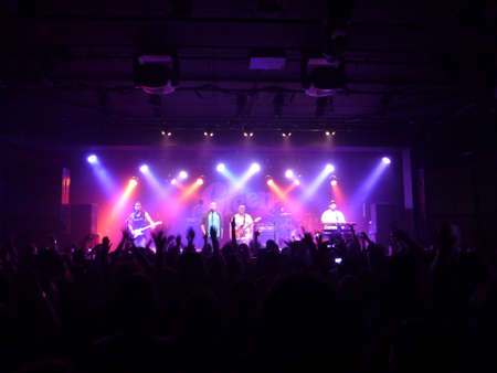 HONOLULU - OCTOBER 18, 2013: Hawaiian Style band the Green sing into mic while playing instruments to make music at concert at the Republik.のeditorial素材