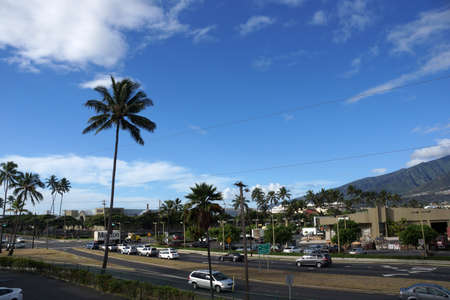 KAHULUI, MAUI - OCTOBER 2: Cars travel along busy intersect with Queen Kaahumanu Center in the distance on a beautiful day on October 2, 2014 Maui.のeditorial素材